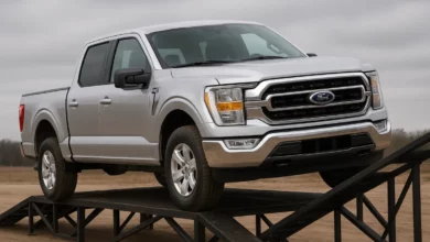 The image features a pickup truck positioned on an inclined metal ramp, facing slightly towards the right.