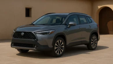 The image features two modern crossover vehicles, positioned on a paved terrace in front of a traditional stucco building.