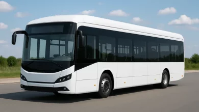 The image features a modern electric bus, prominently parked on a smooth road.